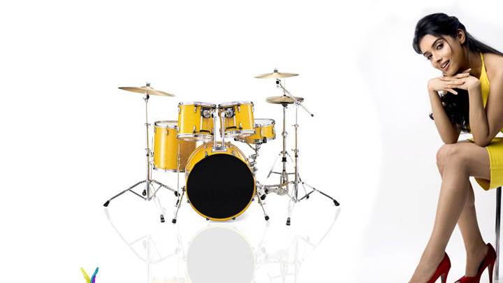 Cute Asin Thottumkal Sitting On a Chair With Drums