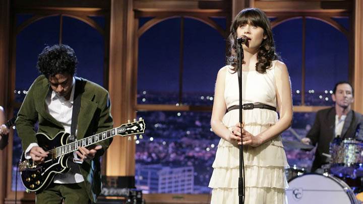 Zooey Deschanel Singing On Stage In White Dress