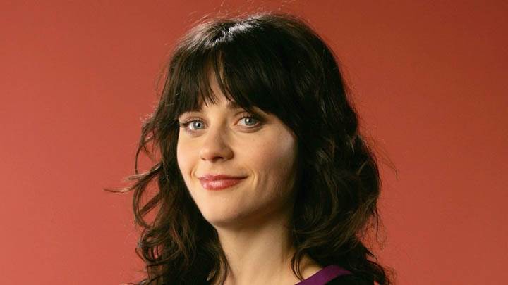 Zooey Deschanel Smiling In Front Of Camera