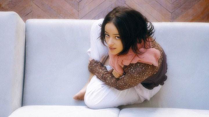 Alizee Jacotey Siting On Sofa And Looking Front