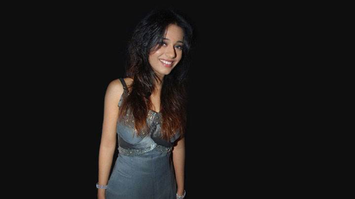 Amrita Rao Smiling In Grey Dress And Black Background