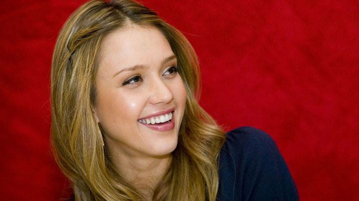 Jessica Alba Smiling In Blue Dress And Red Background